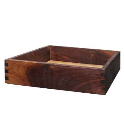 Finger-jointed walnut drawer box with dovetail-style corners and a light plywood bottom.